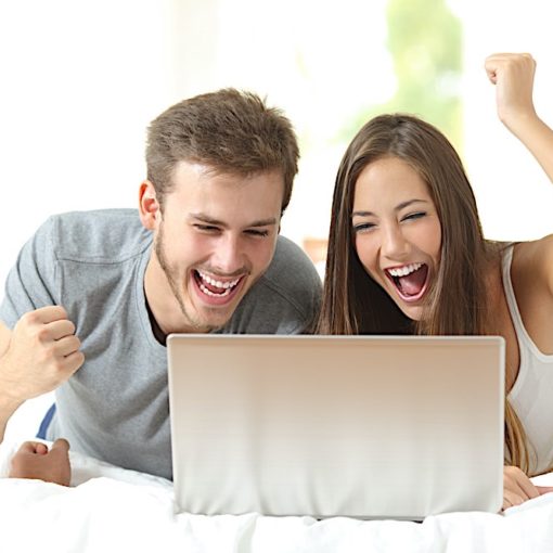 Euphoric marriage winning with a laptop at home